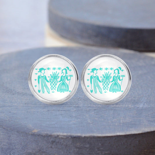 Butterprint Pyrex people printed on surgical steel stud earrings displayed on a gray wood background.